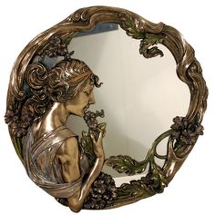 Espejo con acabado dorado con marco vegetal y figura femenina