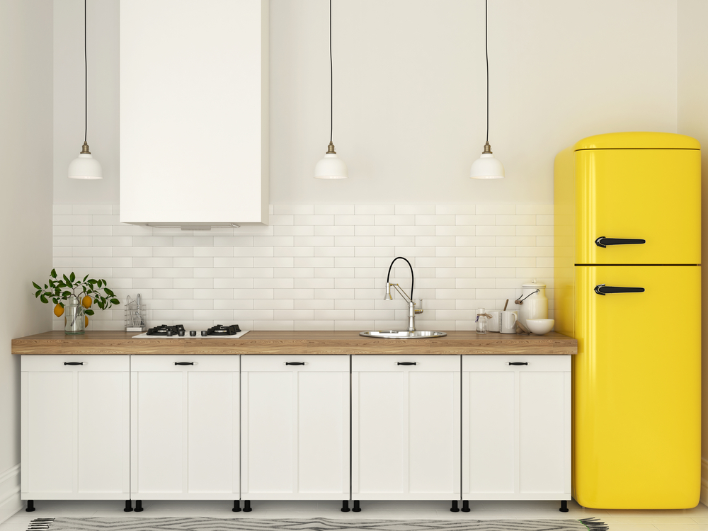 Yellow fridge in white kitchen.
