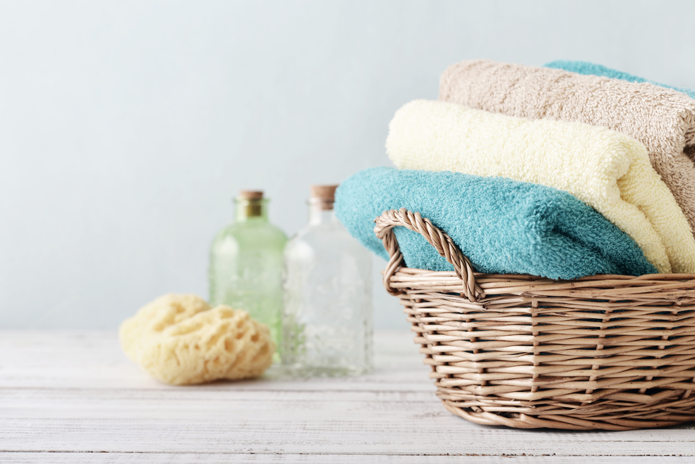 Bath towels from the pastel range: blue, beige, light yellow.