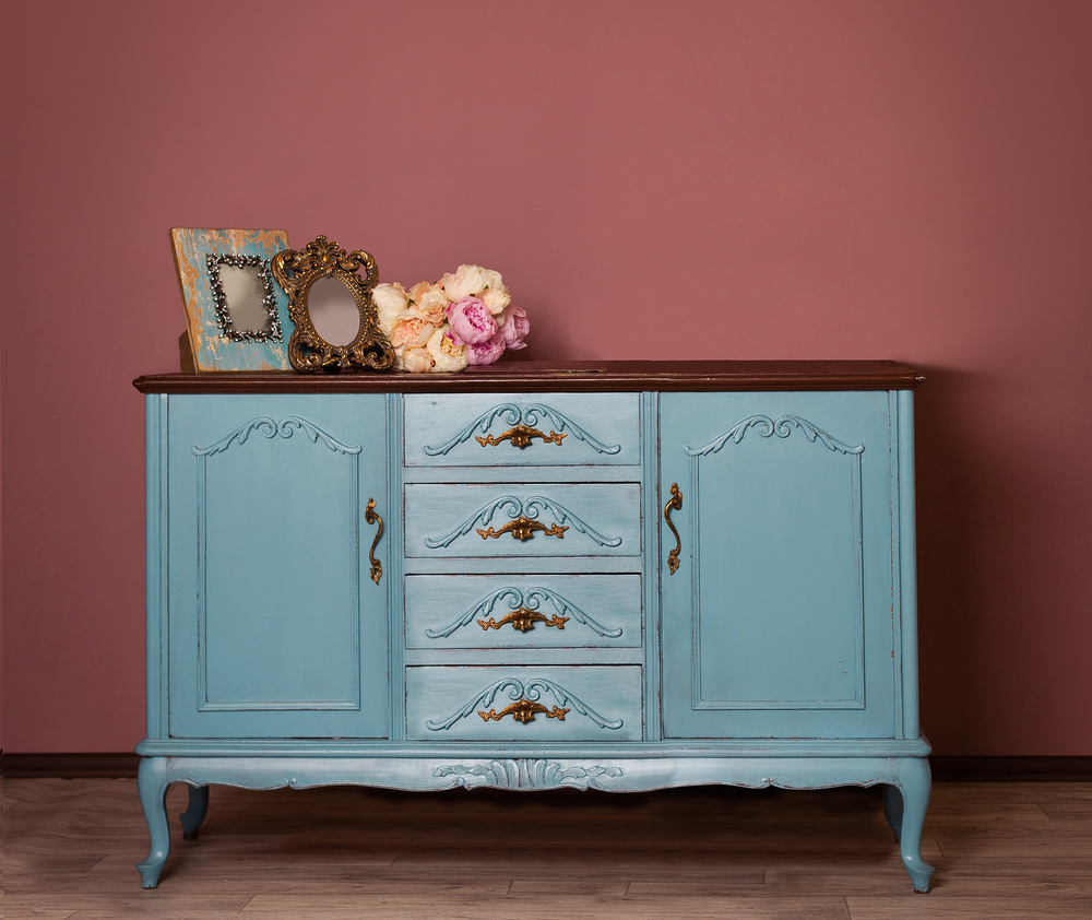 A turquoise and gold vintage dresser.
