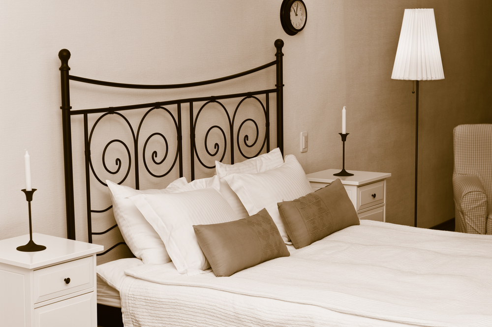 A wrought iron headboard is elegant and sophisticated.