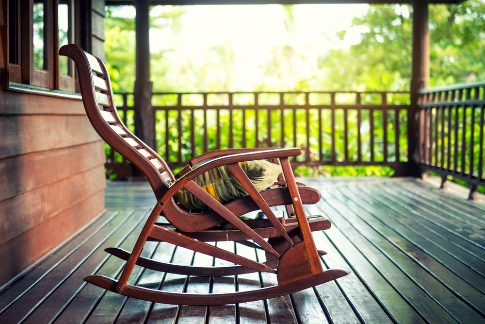 A rocking chair on a porch.