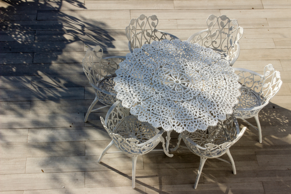 An intricate wrought iron patio table.
