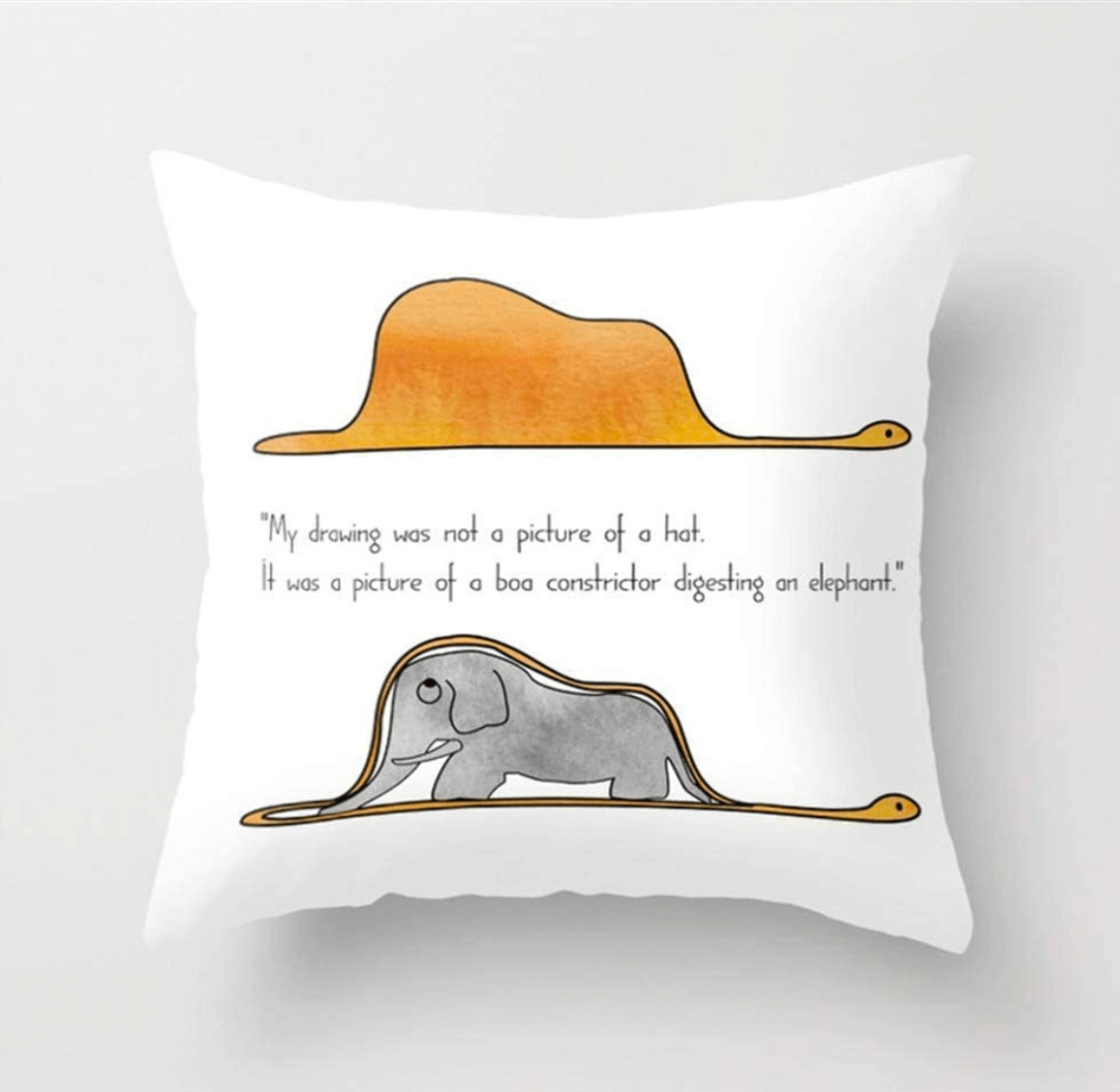 A throw pillow with a drawing from "The Little Prince" that reads "My drawing was not a picture of a hat. It was picture of a boa constrictor digesting an elephant."