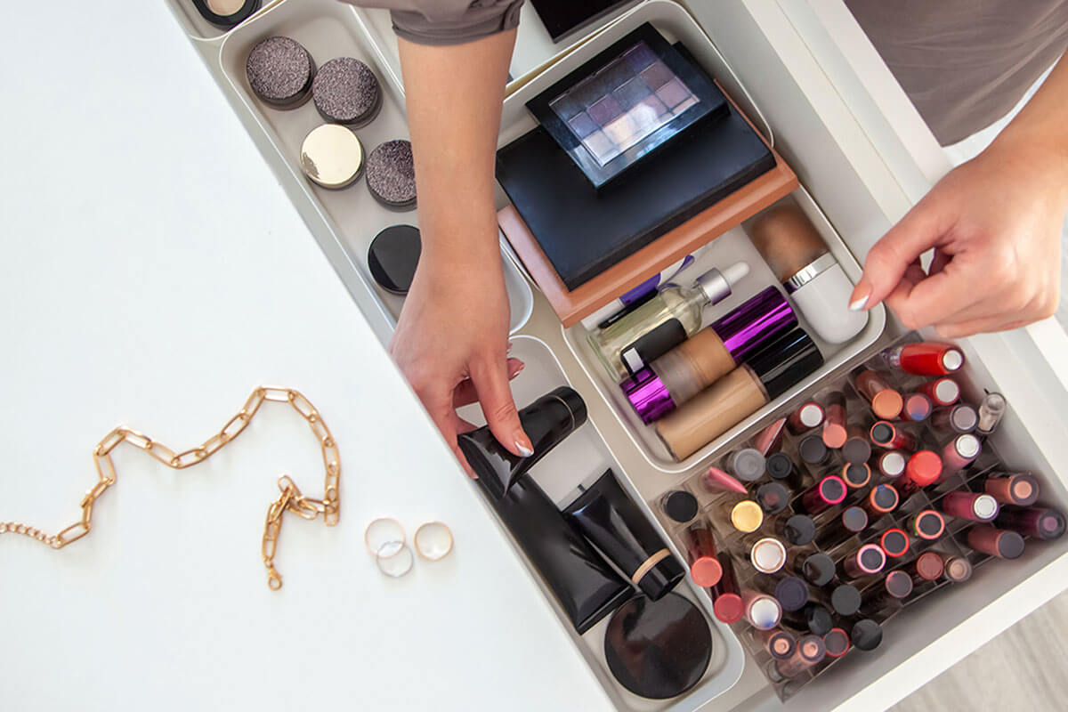 Organize makeup on trays.