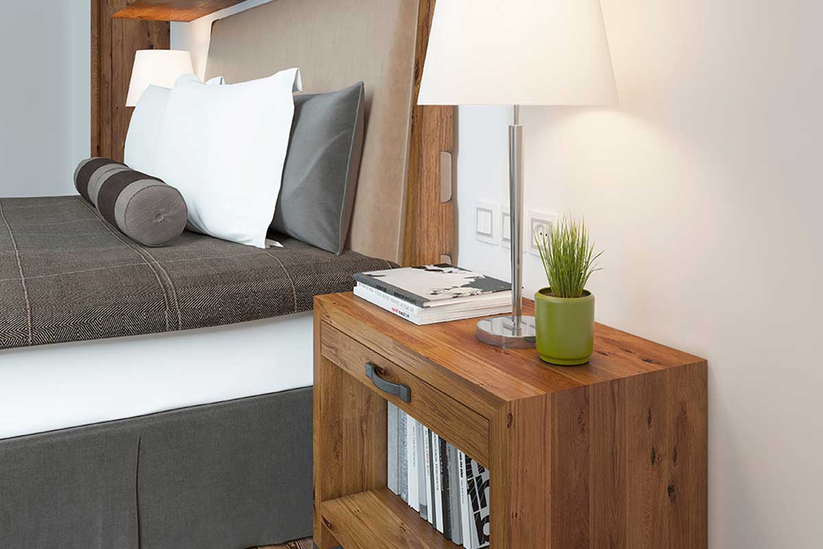 Place a nightstand on your hotel bed at home.