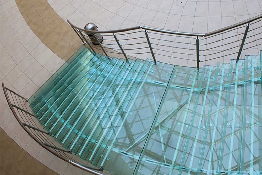 Las escaleras de vidrio permiten el paso de la luz a través de los peldaños.