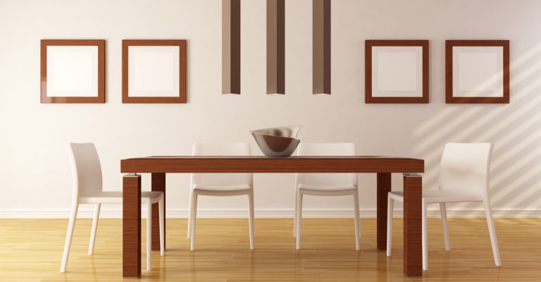 sala da pranzo con sedie bianche e tavolo in legno scuro