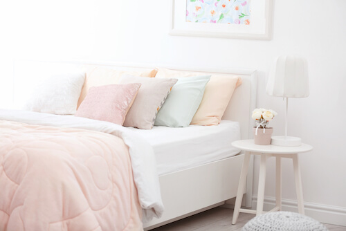 letto cuscini e trapunta in colori pastello