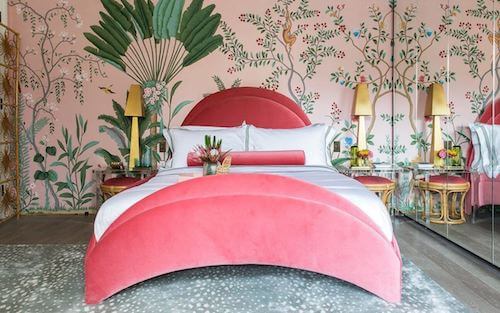 Camera da letto con carta da parati con stampe in stile tropicale.