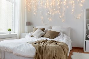 Bedrooms with white walls look even more beautiful when decorated with fairy lights.
