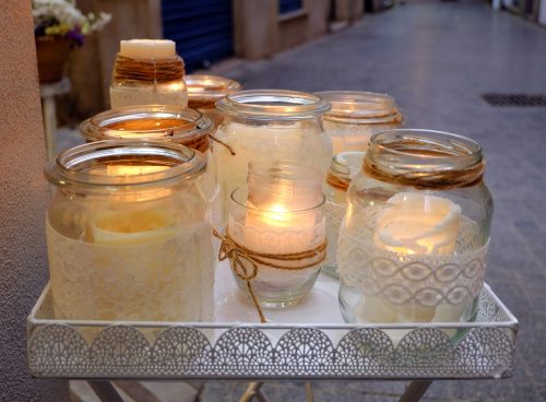 Use decorated glass jars as candle holders
