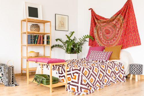 You could hang a printed fabric with mandalas behind the bedhead