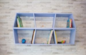 If you don't have much space, a small floating bookcase is a great option.