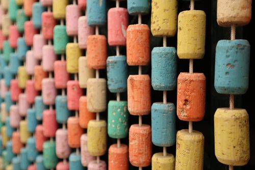 You could create a colorful curtain to decorate with corks
