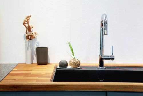 Faucet attached to a black sink