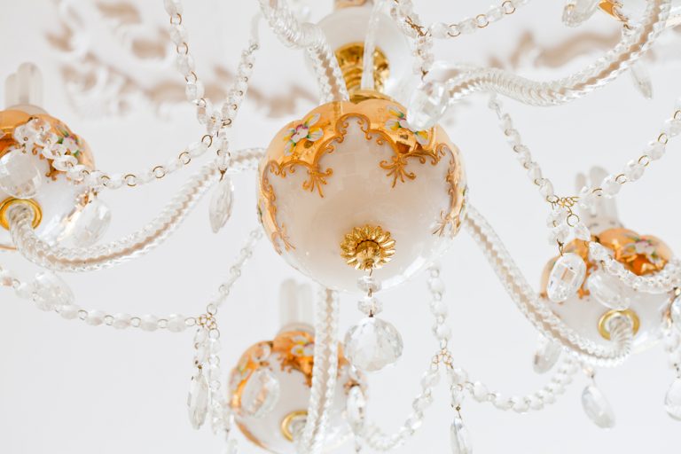 An ornate gold and white chandelier.