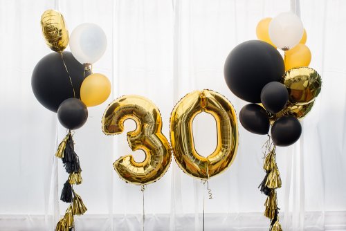 Black balloons and number balloons in gold that say "30".