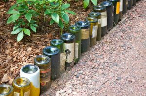 Use wine bottles to create the border for your garden path.