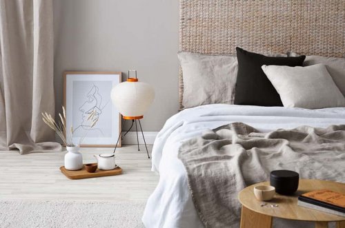 When decorating with rugs, why not hang one on the wall to use as a bed headrest?