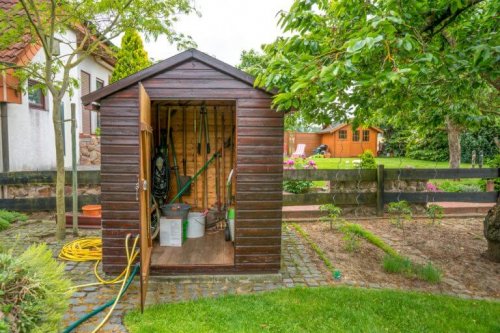 Brown garden shed used as a toolshed