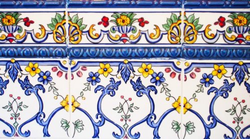 Use a combination of large tiles and frieze tiles for decorating your kitchen to add a splash of color and class