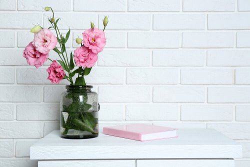 Using flower vases is a great way to decorate shelves with jars