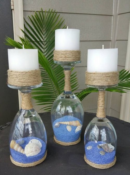 Use wine glasses, colored sand, seashells and candles to create beautiful jars with sand