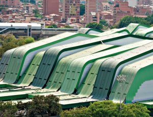 building with yellow and gray curved fiber cement panels