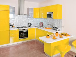 A kitchen with yellow cabinets and drawers