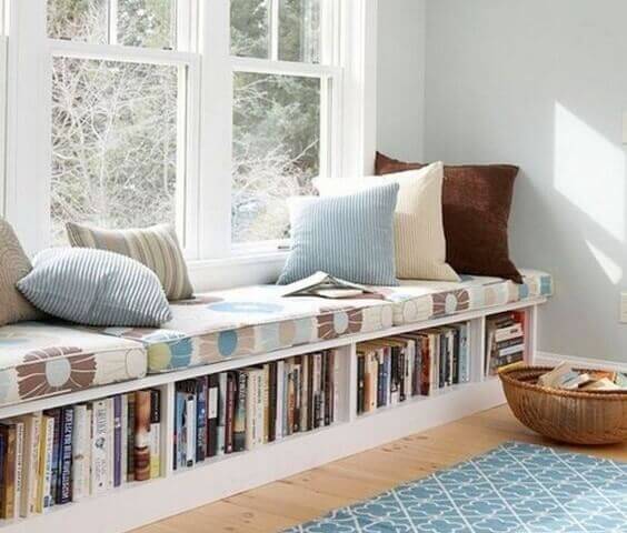 A great way to include book decor in your home is to create a window seat with storage space below for books