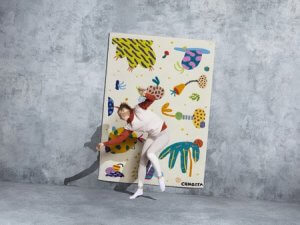 The artist Chiaozza posing with their colorful rug.