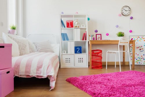A pink long pile rug in a bedroom