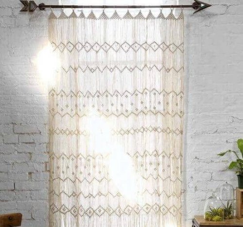 A white macrame curtain lets only diffused light into the room