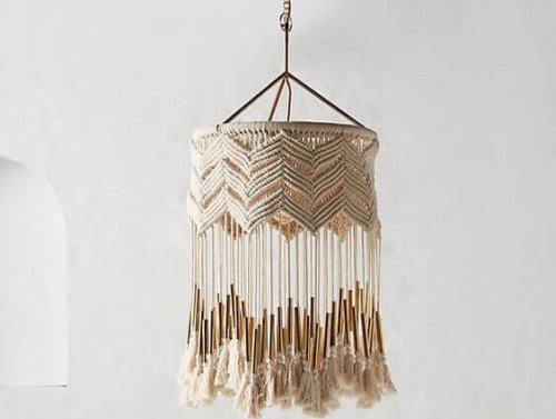 A hanging lamp shade done in cream wool