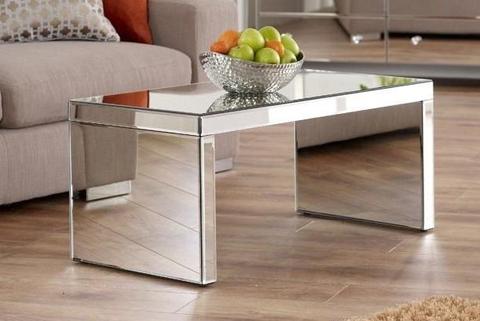 A coffee table with mirrors on all sides.