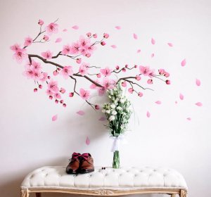 An entryway with decorated with wall decals that come together to look like a cherry blossom shedding its pink leaves.