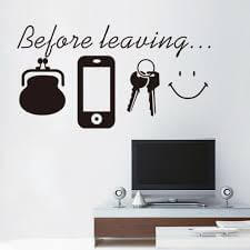 A decal that says "before leaving" with pictures of a phone, keys, purse, and smile.