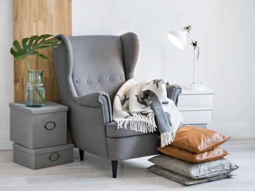 A gray armchair in a space for reading or relaxing.