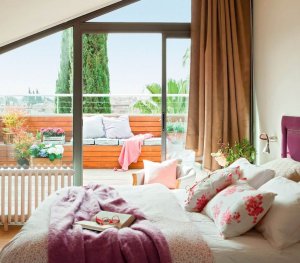 A bedroom with an exterior patio.