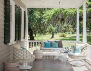 An American-style porch with columns and chairs.