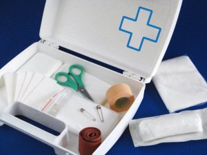 A first aid kit with scissors and bandages.