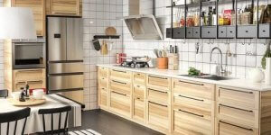Black cabinets fixed above a kitchen sink.