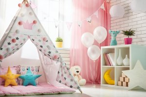 A kids playroom with a tent and stuffed animals.