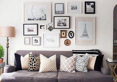 A sofa with decorative pictures above it.