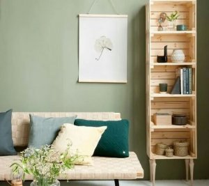 A wooden shelf is standing beside a couch.