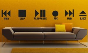 Vinyl stickers on a wall showing the various options on a CD or DVD player.