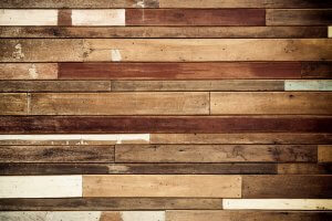 A hardwood floor with streaks and scuffs.