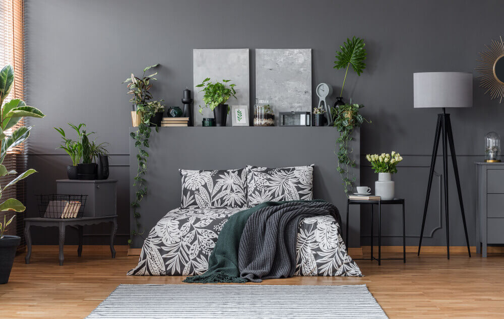 A bedroom with lots of dark gray.
