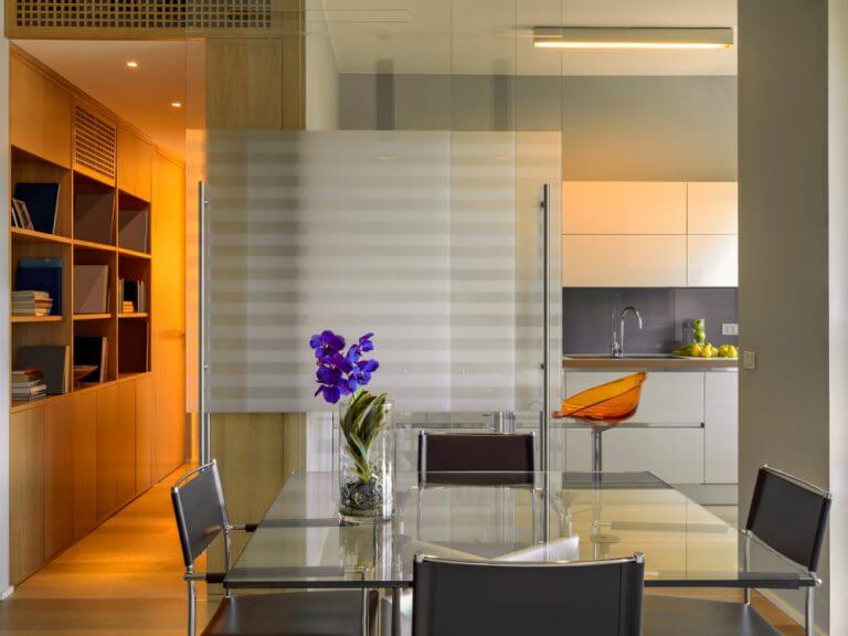 A dining room with frosted glass doors.